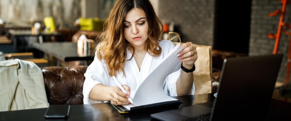 Women Works on Resume in Cafe