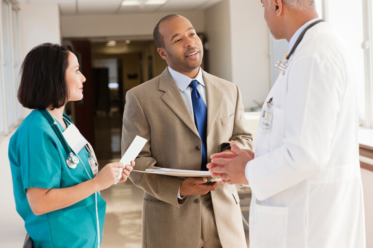 Hospital administrator talking to two doctors