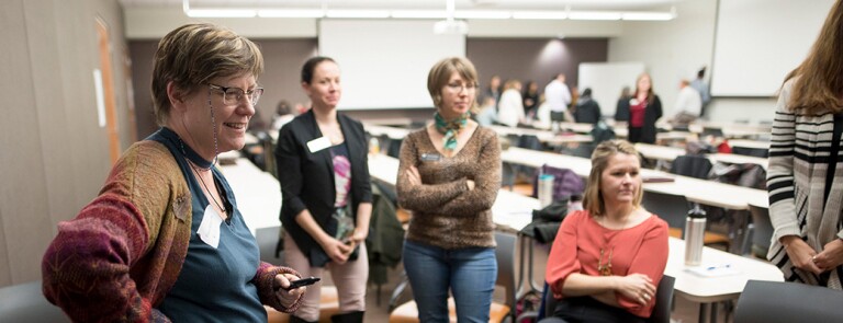 Group of Chico State faculty talk in a classroom