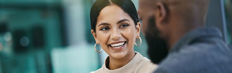 A businesswoman has a meeting with her colleague while using a digital tablet.