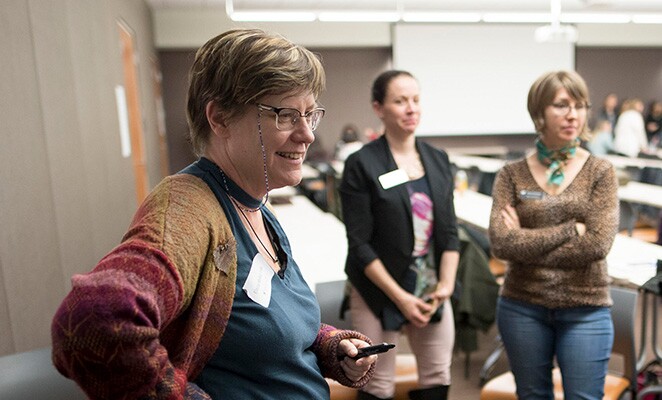 Group of Chico State faculty talk in a classroom
