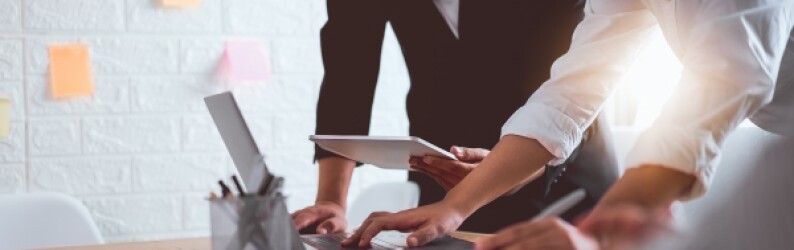 Two people at a work table planning out a business process