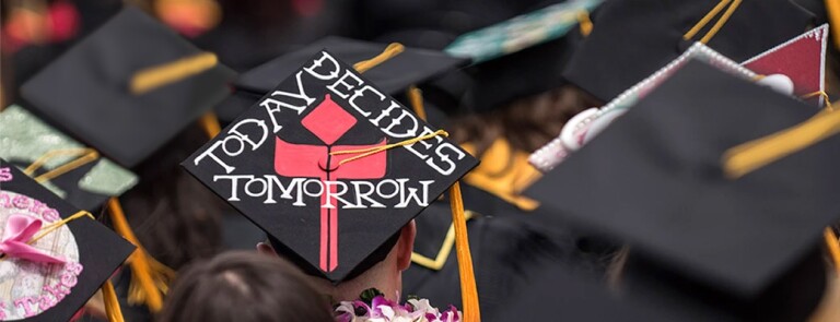 Group of students at graduation. Mortarboard in center reads Today Decides Tomorrow with California State University, Chico logo