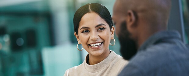 A businesswoman has a meeting with her colleague while using a digital tablet.