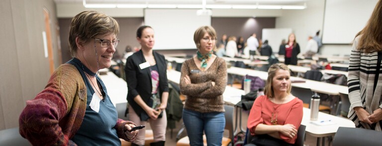 Group of Chico State faculty talk in a classroom