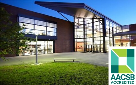 AACSB accredited logo with school building in background